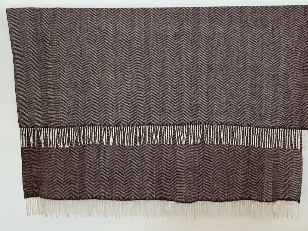 Dark Brown herringbone woven blanket with white fringe on a white background